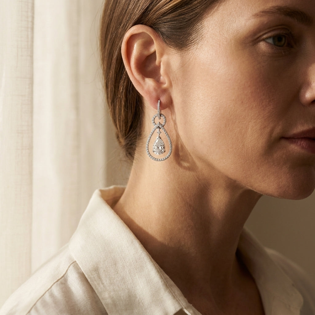 White gold diamond drop earrings worn by a model in soft afternoon light, editorial lifestyle photo