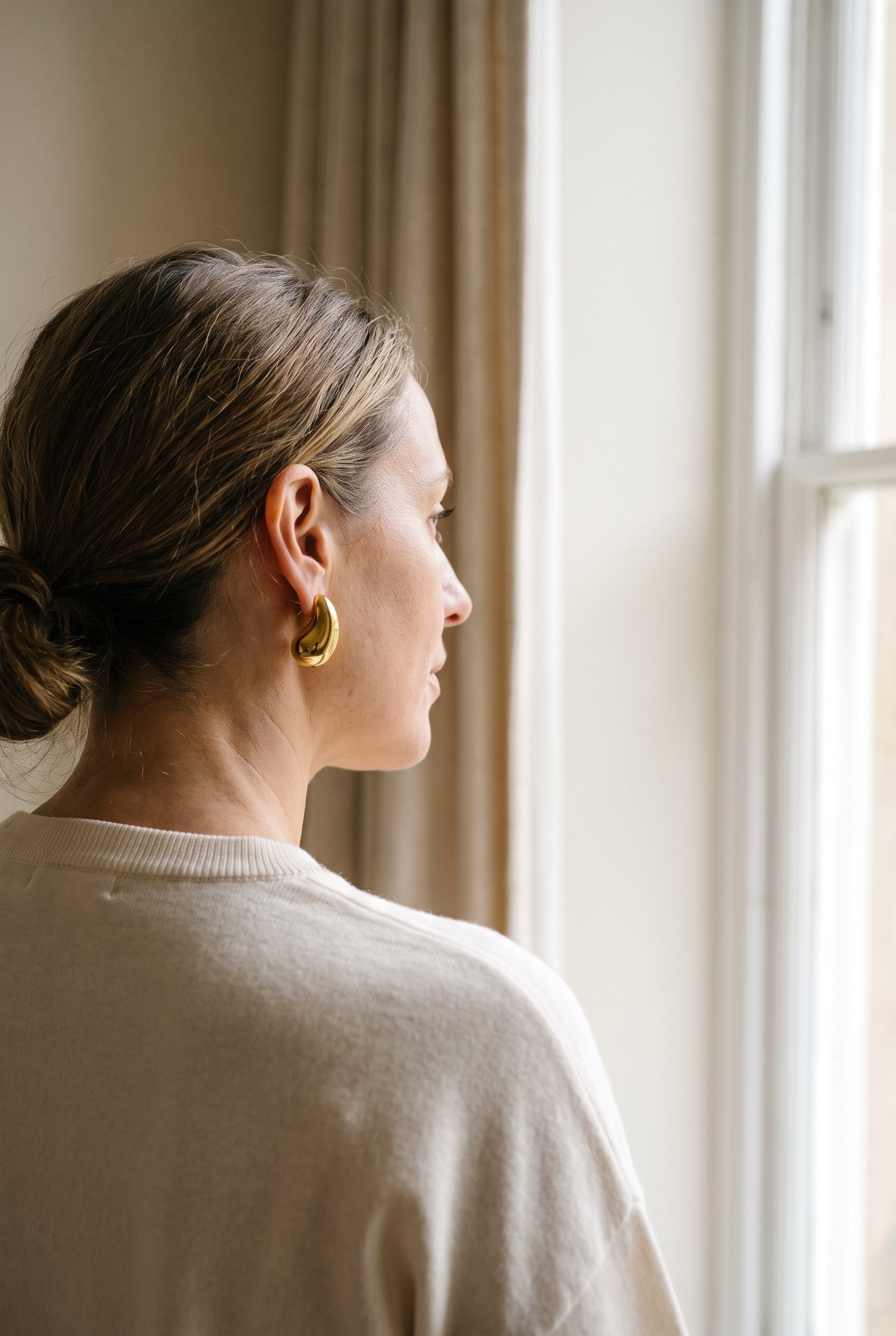 Tiffany & Co. Elsa Peretti Yellow Gold Bean Clipback Earrings — shown worn, second view