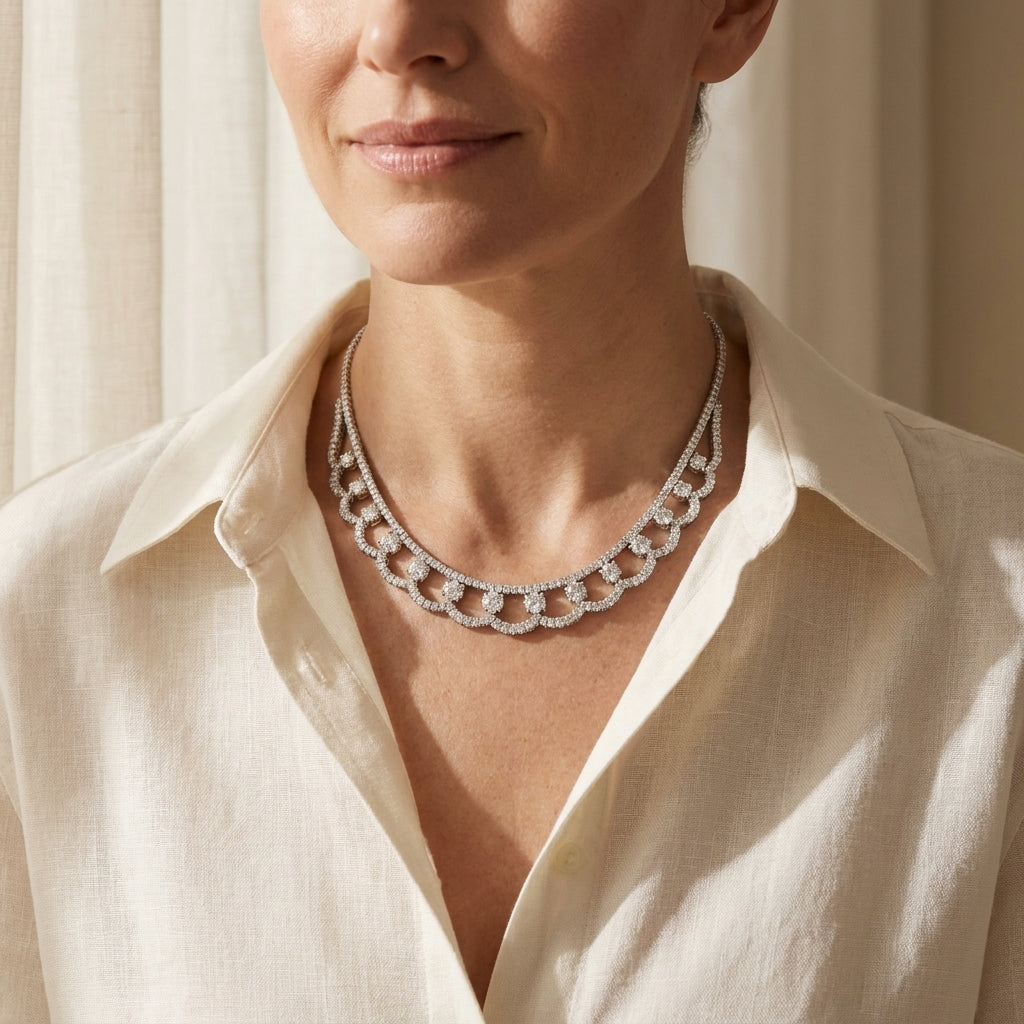 White gold diamond choker necklace worn at an open linen collar, editorial lifestyle photo